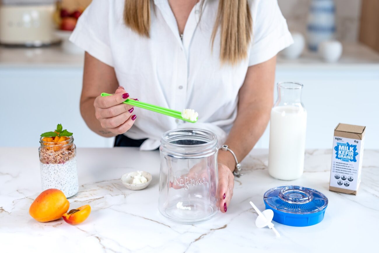 A person holding a jar with food on itAI-generated content may be incorrect.